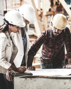 contractors going over a blueprint on public school project