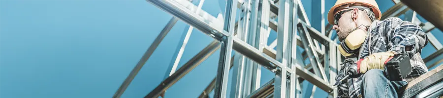 construction worker standing on a structure he's building on a jobsite
